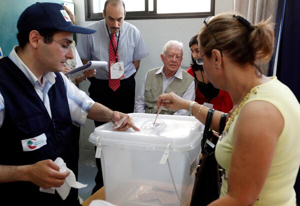 FILE - Former U.S. President Jimmy Carter, center, monitors voting at a polling station in Beirut's Christian sector of Ashrafieh, Lebanon, on June 7, 2009. (AP Photo/Hussein Malla, File)