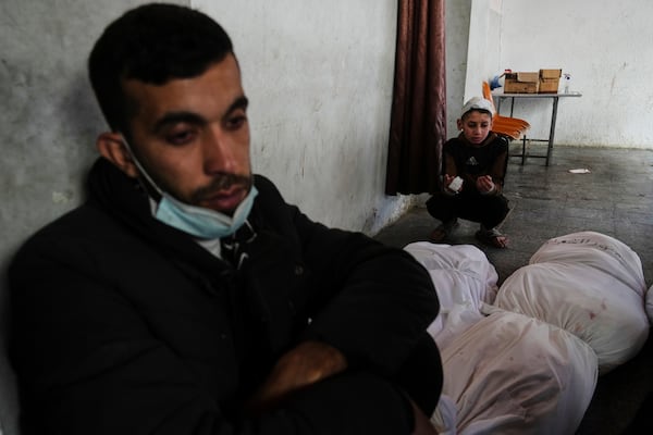 Palestinians mourn over the bodies of Al-Mashharawi family members, who were killed in an Israeli airstrike that hit their home, at Al-Ahli Hospital in Gaza City on Saturday, March 22, 2025. (AP Photo/Jehad Alshrafi)