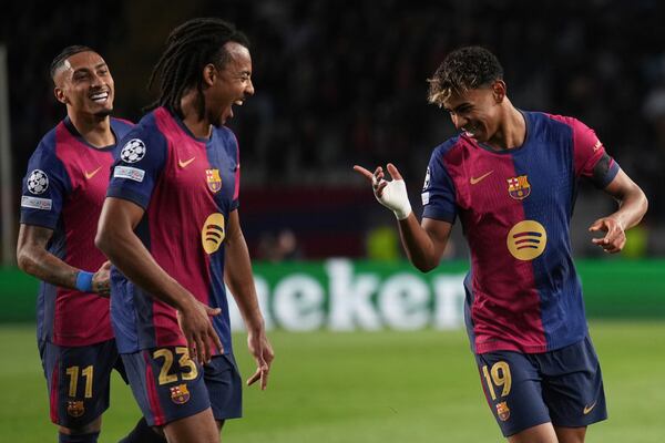 Barcelona's Lamine Yamal, right, celebrates with his teammates after scoring his side's second goal during the Champions League round of 16 second leg soccer match between FC Barcelona and SL Benfica at the Lluis Companys Olympic Stadium in Barcelona, Spain, Tuesday, March 11, 2025. (AP Photo/Emilio Morenatti)