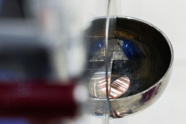 A souvenir penny falls out of a penny press machine at the American Dream mall, Sunday, March 2, 2025, in East Rutherford, N.J. (AP Photo/Julia Demaree Nikhinson)