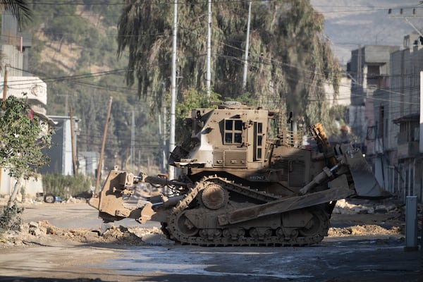 Israeli military bulldozers are seen during a military raid in the Nur Shams refugee camp near the West Bank city of Tulkarem, Tuesday, Dec. 24, 2024. (AP Photo/Majdi Mohammed)