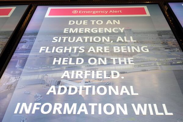 A information board displays a message at Ronald Reagan Washington National Airport, Wednesday, Jan. 29, 2025, in Arlington, Va. (AP Photo/Julio Cortez)