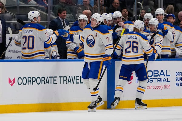 Buffalo Sabres' Tage Thompson (72) celebrates with teammates after scoring an empty-net goal during the third period of an NHL hockey game against the New York Islanders Monday, Dec. 23, 2024, in Elmont, N.Y. (AP Photo/Frank Franklin II)