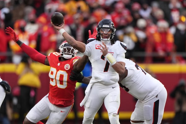 Houston Texans quarterback C.J. Stroud (7) throws under pressure from Kansas City Chiefs defensive end Charles Omenihu (90) during the first half of an NFL football AFC divisional playoff game Saturday, Jan. 18, 2025, in Kansas City, Mo. (AP Photo/Charlie Riedel)