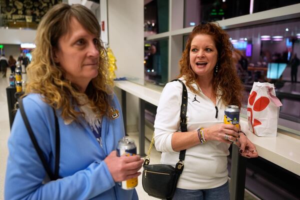 Kristiun Westphal , left, and Missy Vraney talk about Third Space Marquette beer before an NCAA college basketball game Tuesday, Feb. 11, 2025, in Milwaukee. (AP Photo/Morry Gash)