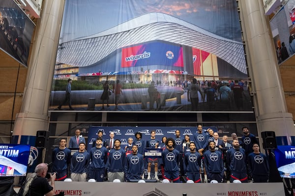 Members of the Washington Wizards NBA Basketball team pose for a photograph with Ted Leonsis, owner of the Washington Wizards NBA basketball team and Washington Capitals NHL hockey team, NBA Commissioner Adam Silver, District of Columbia Mayor Muriel Bowser, and other officials, during an event announcing the start of work on a new Capital One Arena Gallery Place Atrium, Thursday, Dec. 19, 2024, in Washington. (AP Photo/Jacquelyn Martin)