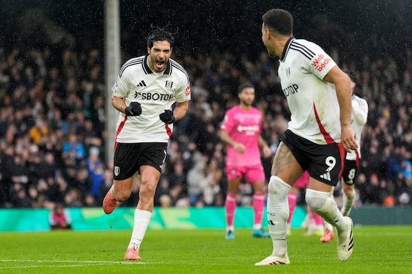 Fulham's Raul Jimenez, left, celebrates after scoring his sides first goal from the penalty spot during the English Premier League soccer match between Fulham and Ipswich Town at Craven Cottage stadium, London, Sunday Jan. 5, 2025. (Andrew Matthews/PA via AP)