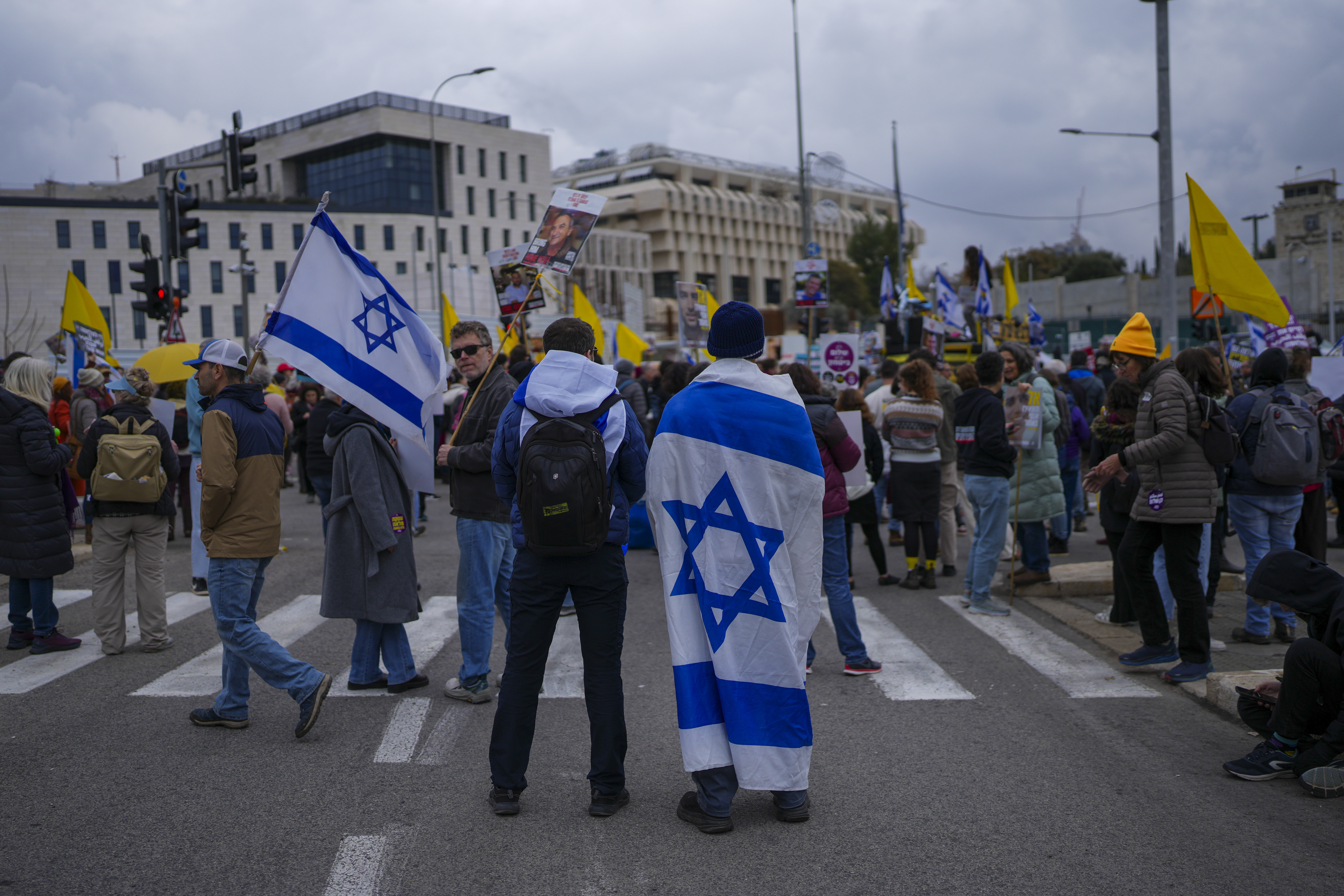 Relatives and supporters of hostages held by Hamas in the Gaza Strip protest outside the prime minister's office in Jerusalem on Tuesday, Feb. 11, 2025. after Hamas announced it would delay a planned hostage release after accusing Israel of violating a fragile ceasefire. (AP Photo/Ohad Zwigenberg)