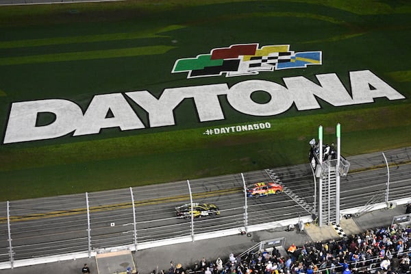 William Byron (24) crosses the finish line in front of Tyler Reddick (45) to win the NASCAR Daytona 500 auto race at Daytona International Speedway, Sunday, Feb. 16, 2025, in Daytona Beach, Fla. (AP Photo/Phelan M. Ebenhack)