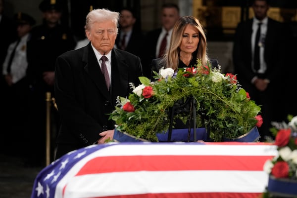 President-elect Donald Trump and Melania Trump pause at the flag-draped casket of former President Jimmy Carter as he lies in state in the rotunda of the U.S. Capitol in Washington, Wednesday, Jan. 8, 2025. (AP Photo/J. Scott Applewhite