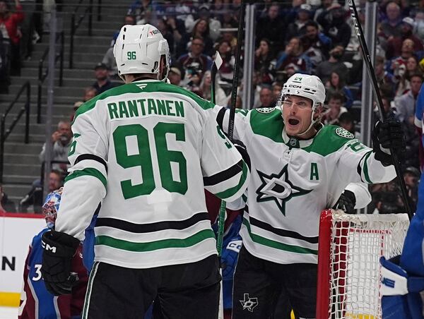 Dallas Stars right wing Mikko Rantanen (96) congratulates center Roope Hintz, after, after his goal in the second period of Game 6 of an NHL hockey first-round playoff series against the Colorado Avalanche, Thursday, May 1, 2025, in Denver. (AP Photo/David Zalubowski)
