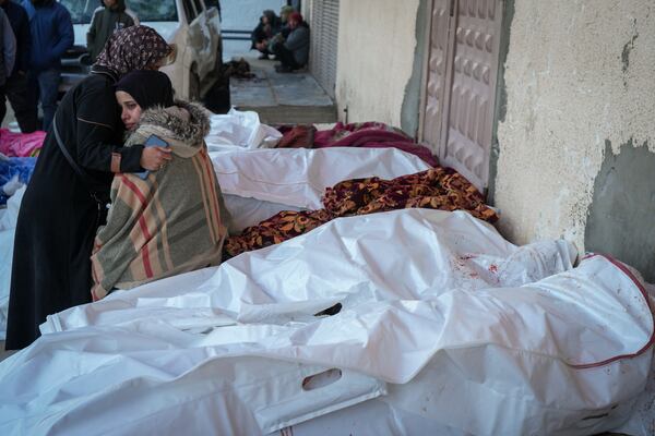 Relatives mourn over the bodies of victims of overnight Israeli army strikes at multiple locations in central Gaza Strip, at Al-Aqsa Martyrs Hospital in Deir al-Balah, Friday, Jan. 3, 2025. According to Al-Aqsa Martyrs Hospital, 30 people, including 10 women and 7 children, were killed in several attacks overnight in central Gaza. (AP Photo/Abdel Kareem Hana)