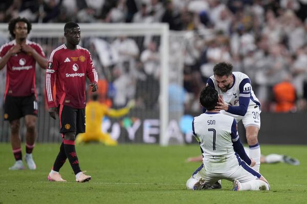 Tottenham's Son Heung-min and Tottenham's Rodrigo Bentancur celebrate at the end of the Europa League final soccer match between Tottenham Hotspur and Manchester United at the San Mames Stadium in Bilbao, Spain, Wednesday, May 21, 2025. (AP Photo/Bernat Armangue)