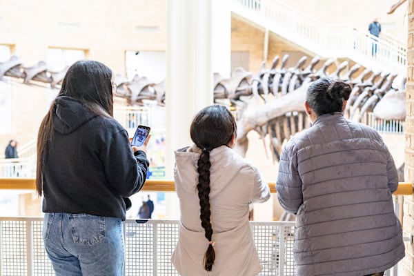 Three humanitarian parole beneficiaries from Venezuela sponsored by Sandra McAnany, enjoying a day at the Fernbank Museum, Dec. 16, 2023, in Atlanta, Ga. (Sandra McAnany via AP)