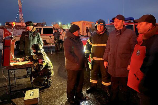 In this photo released by Governor of the Saratov region Roman Busargin telegram channel on Wednesday, Jan. 8, 2025, Governor of the Saratov region Roman Busargin, second right, speaks to firefighters and rescuers at the industrial side damaged after Ukrainian drones' attack in Saratov, Russia. (Governor of the Saratov region Roman Busargin telegram channel via AP)