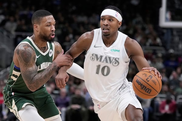 Dallas Mavericks' Brandon Williams tries to get past Milwaukee Bucks' Damian Lillard during the first half of an NBA basketball game Wednesday, March 5, 2025, in Milwaukee. (AP Photo/Morry Gash)