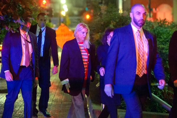 Attorney General Pam Bondi, center, walks to her car as law enforcement work the scene after two staff members of the Israeli Embassy in Washington were shot and killed outside the Capital Jewish Museum, Thursday, May 22, 2025, in Washington. (AP Photo/Rod Lamkey, Jr.)