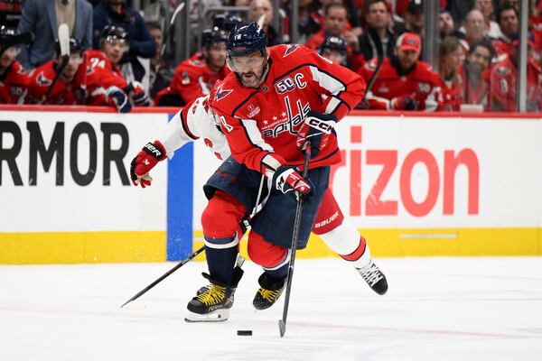 Washington Capitals left wing Alex Ovechkin (8) skates with the puck in the first period of Game 2 of a second-round NHL hockey playoff series against the Carolina Hurricanes, Thursday, May 8, 2025, in Washington. (AP Photo/Nick Wass)
