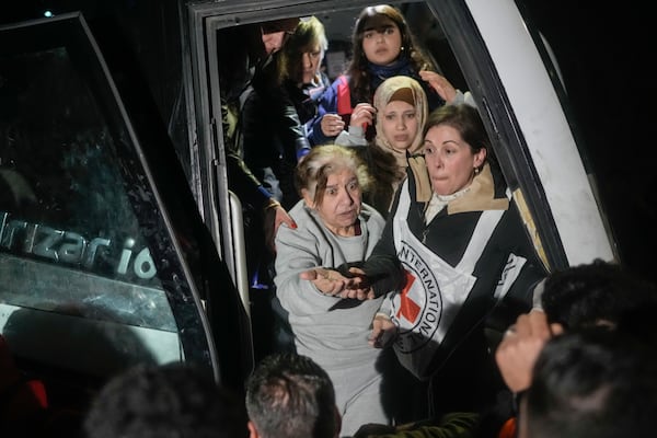 Female Palestinian prisoners disembark from a bus after being released from an Israeli prison, in the West Bank city of Beitunia, early Monday, Jan. 20, 2025. (AP Photo/Leo Correa)