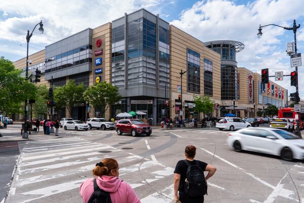 People wait to cross an intersection in front of the Columbia Heights metro station, Tuesday, May 6, 2025, in Washington. (AP Photo/Julia Demaree Nikhinson)