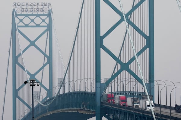 Trucks enter into the United States from Ontario, Canada across the Ambassador Bridge, Monday, Feb. 3, 2025, in Detroit. (AP Photo/Paul Sancya)