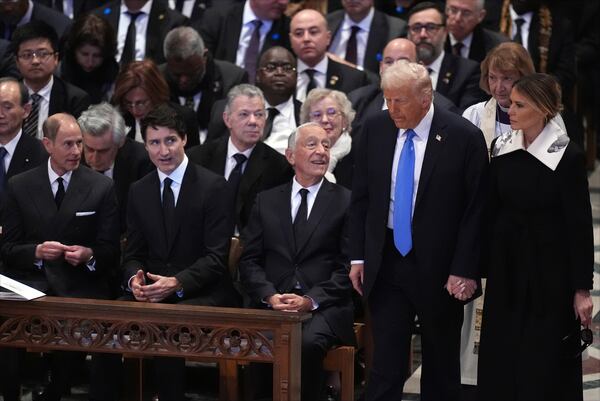 President-elect Donald Trump and Melania Trump arrive before the state funeral for former President Jimmy Carter at Washington National Cathedral in Washington, Thursday, Jan. 9, 2025, as Prince Edward, Duke of Edinburgh, left, and Canada's Prime Minister Justin Trudeau watch. (AP Photo/Jacquelyn Martin)