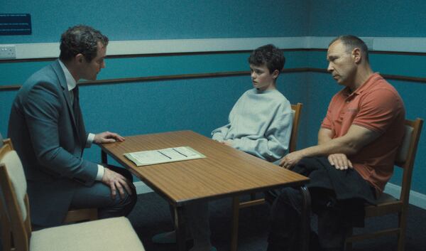 This image released by Netflix shows Mark Stanley, from left, Owen Cooper and Stephen Graham in a scene from "Adolescence." (Netflix via AP)