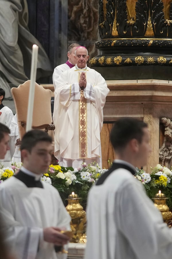 Archbishop Rino Fisichella, center, celebrates a mass for the jubilee of deacons Sunday, Feb. 23, 2025, in St. Peter's Basilica at The Vatican that was supposed to be presided over by Pope Francis who was admitted over a week ago at Rome's Agostino Gemelli Polyclinic and is in critical conditions. (AP Photo/Alessandra Tarantino)