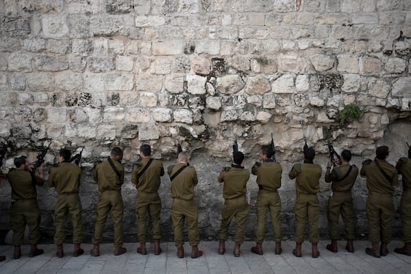 Israeli Defense Forces paratroopers clear ammunition from their weapons before entering the Western Wall plaza in Jerusalem's Old City for a ceremony on Wednesday, Jan. 8, 2025. (AP Photo/Maya Alleruzzo)