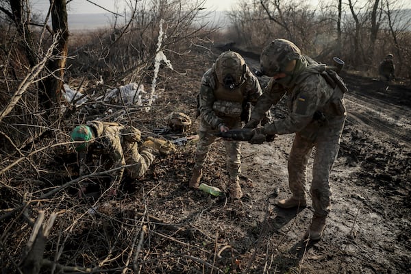 Ukrainian servicemen collect damaged ammunition on the road at the front line near Chasiv Yar town, in Donetsk region, Ukraine, Ukraine, Friday, Jan. 10, 2025. (Oleg Petrasiuk/Ukraine's 24th Mechanised Brigade via AP)