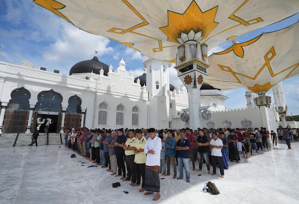 People perform a Friday prayer at Baiturrahman Grand Mosque in Banda Aceh, Indonesia, Friday, Dec. 13, 2024. (AP Photo/Achmad Ibrahim)