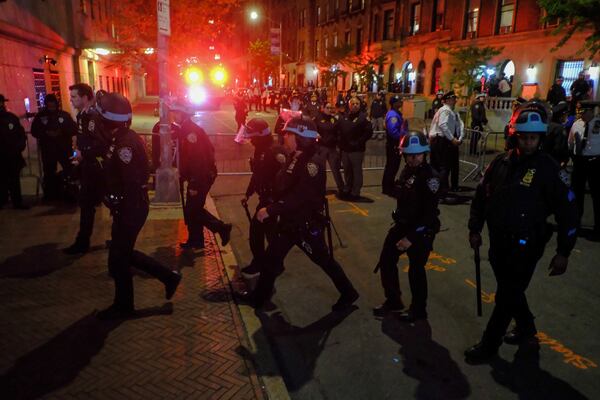 FILE - Members of the New York Police Department strategic response team move towards an entrance to Columbia University, Tuesday, April 30, 2024, in New York. (AP Photo/Julius Motal, File)