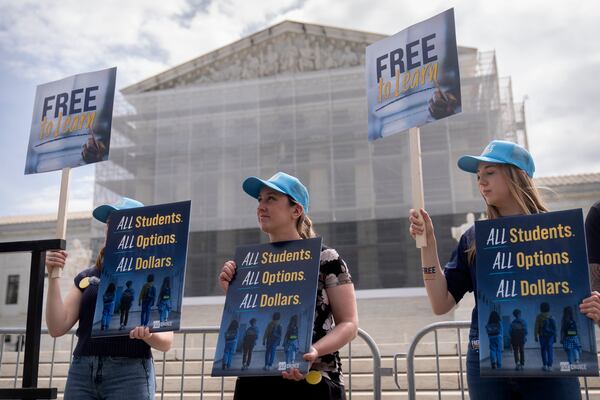 Supporters of charter schools rally outside of the Supreme Court on Wednesday, April 30, 2025, in Washington. (AP Photo/Mark Schiefelbein)