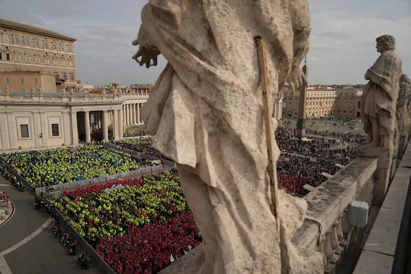 Members of different organizations of volunteers follow Cardinal Michael Czerny, delegate of Pope Francis who is being treated for pneumonia at Rome's Agostino Gemelli Polyclinic, celebrating a mass for the world of volunteers in St. Peter's Square at The Vatican, Sunday, March 9, 2025. (AP Photo/Francisco Seco)