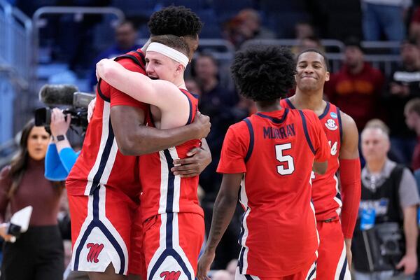 Mississippi forward Malik Dia, left, and guard Sean Pedulla, second from left, hug following their win over Iowa State in the second round of the NCAA college basketball tournament, Sunday, March 23, 2025, in Milwaukee. (AP Photo/Kayla Wolf)