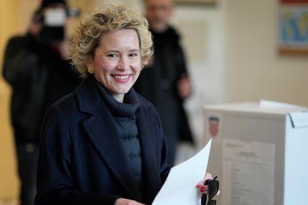 Ivana Kekin, left-green candidate of the (Mozemo) "We Can" arrives at a polling station during presidential elections in Zagreb, Croatia, Sunday, Dec. 29, 2024. (AP Photo/Darko Bandic)