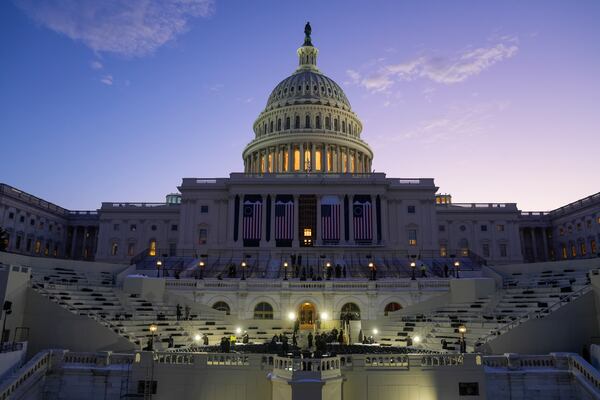 FILE - The sun rises behind the U.S. Capitol as a rehearsal begins on the West Front ahead of President-elect Donald Trump's upcoming inauguration, Sunday, Jan. 12, 2025, in Washington. (AP Photo/Jon Elswick, File)