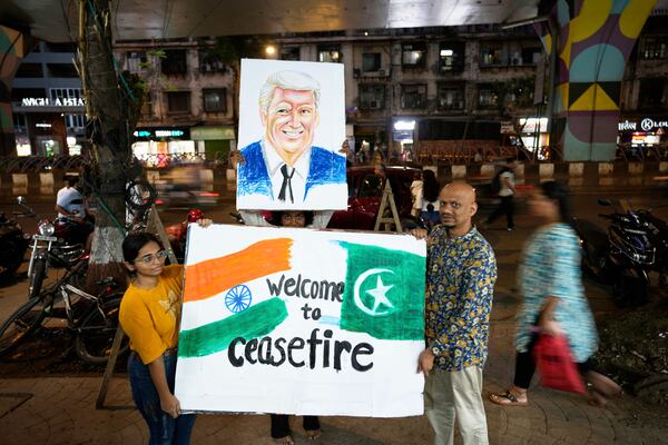 Students of an art school and their teacher carry a hand-drawn portrait of the US President Donald Trump as they celebrate the ceasefire between India and Pakistan, in Mumbai, India, Saturday, May 10, 2025. (AP Photo/Rajanish Kakade)