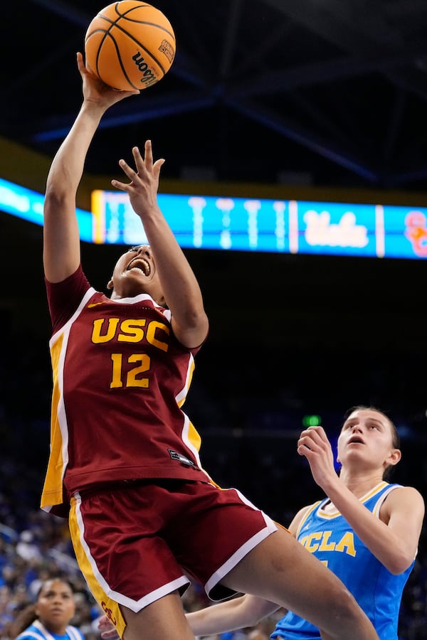 Southern California guard JuJu Watkins, left, shoots as UCLA guard Gabriela Jaquez defends during the second half of an NCAA college basketball game Saturday, March 1, 2025, in Los Angeles. (AP Photo/Mark J. Terrill)