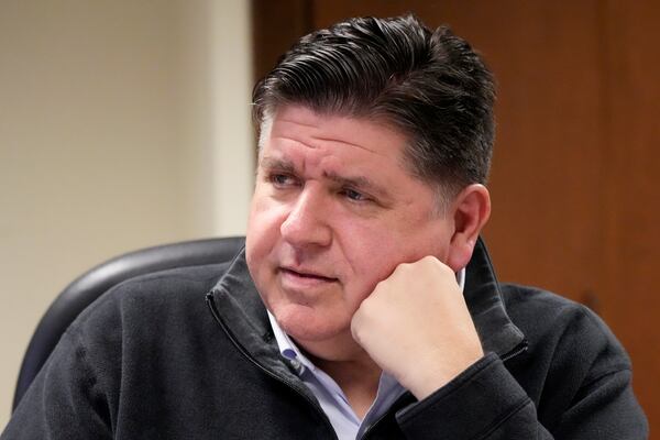 Illinois Gov. JB Pritzker listens to Eric Sedivy, assistant director of Soybean Innovation Lab, during a visit to the lab at the University of Illinois, which is impacted by DOGE funding cuts, in Urbana, Ill., Wednesday, March 19, 2025. (AP Photo/Nam Y. Huh)