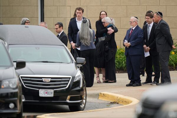 Family and friends gather outside Congregation Beth Torah after a funeral for Sarah Milgrim, a staffer at the Israeli Embassy who was killed last week outside a Washington Jewish museum, Tuesday, May 27, 2025, in Overland Park, Kan. (AP Photo/Charlie Riedel)