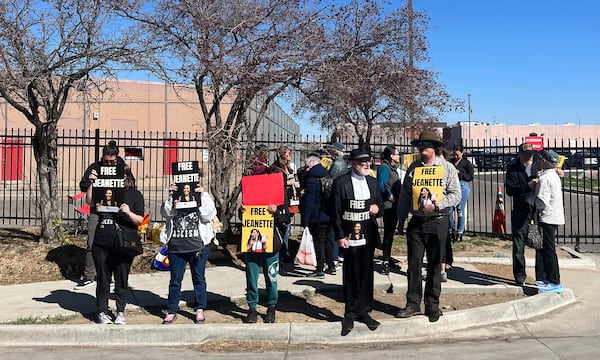 Supporters of Colorado immigration activist Jeanette Vizguerra hold signs outside the U.S. Immigration and Customs Enforcement GEO Group detention facility in Aurora, Colo., Tuesday, March 18, 2025. (RJ Sangosti/The Denver Post via AP)