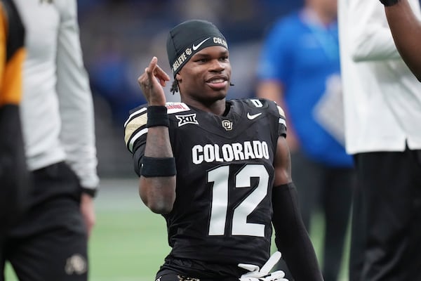 Colorado wide receiver Travis Hunter (12) warms up for the Alamo Bowl NCAA college football game against BYU, Saturday, Dec. 28, 2024, in San Antonio. (AP Photo/Eric Gay)