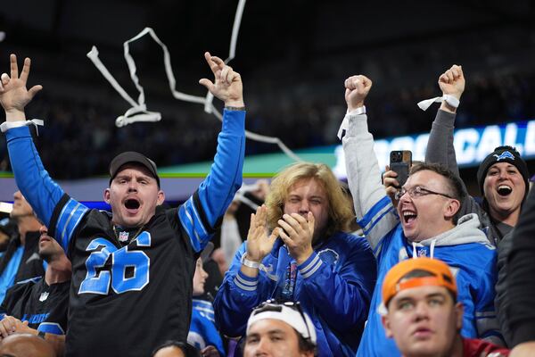 Detroit Lions fans celebrate a touchdown during the second half of an NFL football game between the Detroit Lions and the Minnesota Vikings, Sunday, Jan. 5, 2025, in Detroit. (AP Photo/)