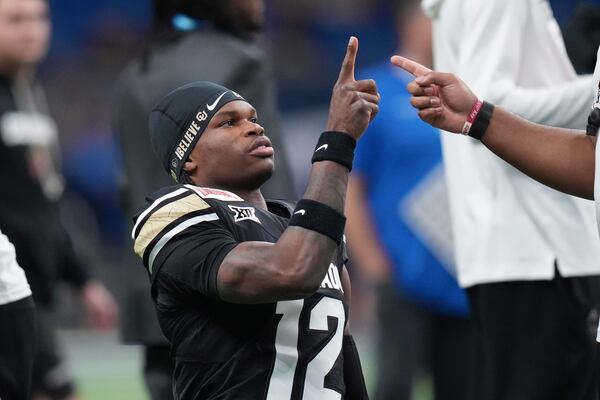 Colorado wide receiver Travis Hunter (12) warms up for the Alamo Bowl NCAA college football game against BYU, Saturday, Dec. 28, 2024, in San Antonio. (AP Photo/Eric Gay)