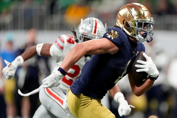 Notre Dame wide receiver Jaden Greathouse scores pasts Ohio State cornerback Jermaine Mathews Jr. during second half of the College Football Playoff national championship game Monday, Jan. 20, 2025, in Atlanta. (AP Photo/Brynn Anderson)