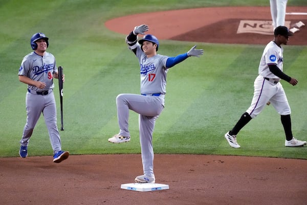 FILE - Los Angeles Dodgers' Shohei Ohtani (17) of Japan, celebrates after hitting a double during the first inning of a baseball game against the Miami Marlins, Thursday, Sept. 19, 2024, in Miami. (AP Photo/Wilfredo Lee, File)