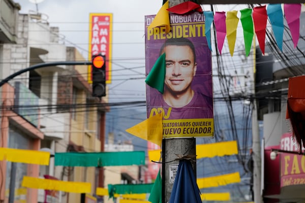 A poster of incumbent presidential candidate, President Daniel Noboa, hangs a street post ahead of the presidential run-off election in Saquisili, Ecuador, Tuesday, Feb. 11, 2025. (AP Photo/Dolores Ochoa)