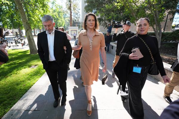 Anamaria Baralt, center, a cousin of Erik and Lyle Menendez, who were convicted of killing their parents in 1989, arrives to court Friday, May 9, 2025, in Los Angeles. (AP Photo/Jae C. Hong)