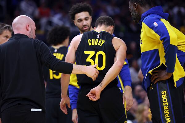 Golden State Warriors' Stephen Curry walks off the court after injuring himself in 3rd quarter against Toronto Raptors during NBA game at Chase Center in San Francisco on Thursday, March 20, 2025. (Scott Strazzante/San Francisco Chronicle via AP)